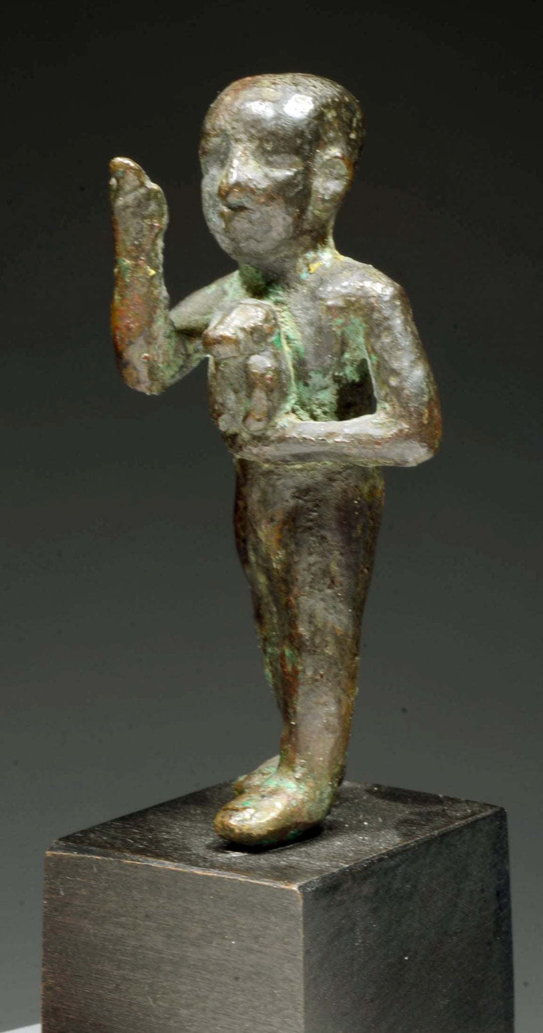 Egyptian Bronze Striding Priest holding a Baboon