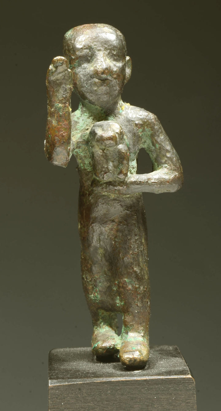 Egyptian Bronze Striding Priest holding a Baboon