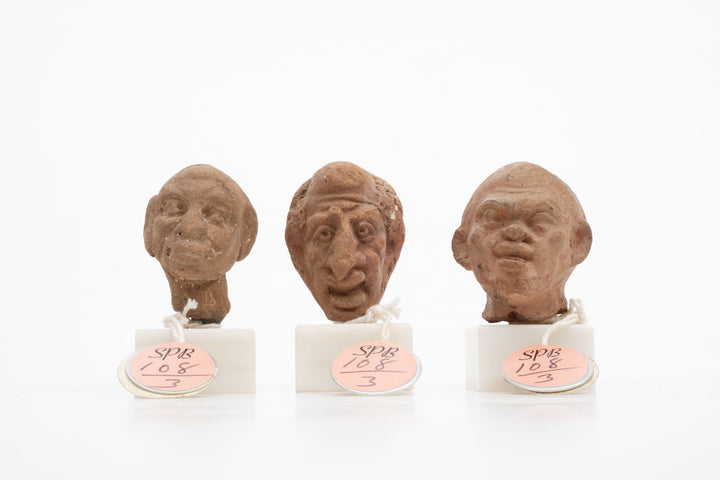 Group of three Hellenistic Alexandrian terracotta grotesque character heads