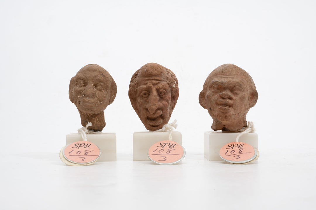 Group of three Hellenistic Alexandrian terracotta grotesque character heads