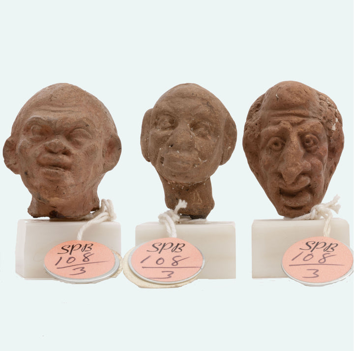 Group of three Hellenistic Alexandrian terracotta grotesque character heads