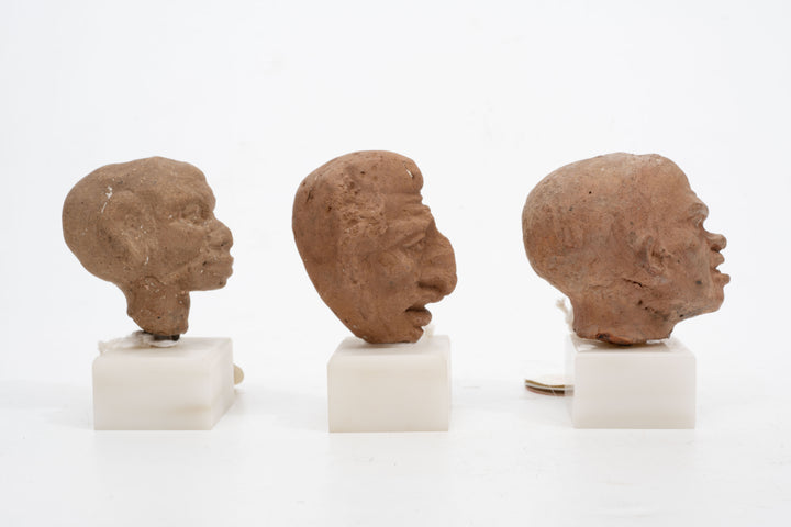 Group of three Hellenistic Alexandrian terracotta grotesque character heads