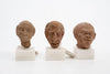 Group of three Hellenistic Alexandrian terracotta grotesque character heads
