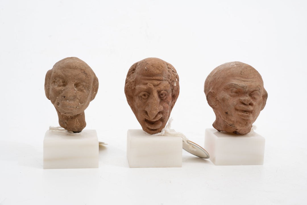 Group of three Hellenistic Alexandrian terracotta grotesque character heads