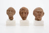 Group of three Hellenistic Alexandrian terracotta grotesque character heads