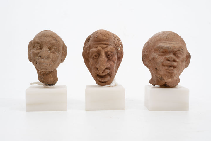 Group of three Hellenistic Alexandrian terracotta grotesque character heads