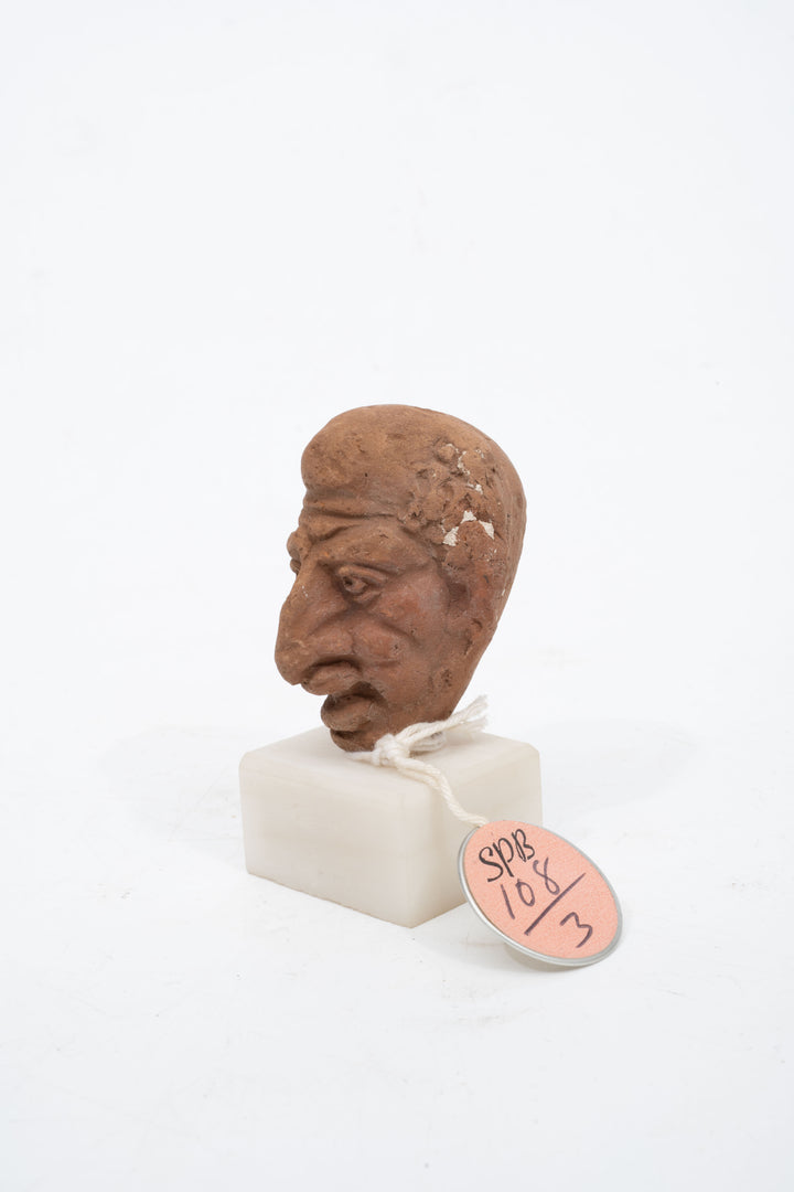Group of three Hellenistic Alexandrian terracotta grotesque character heads