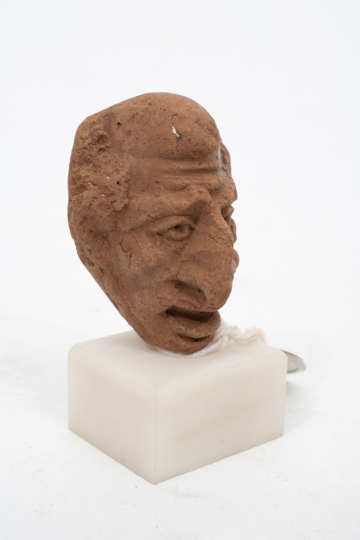 Group of three Hellenistic Alexandrian terracotta grotesque character heads