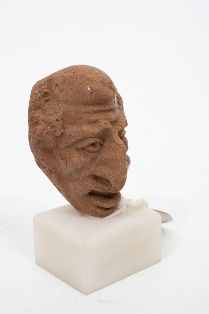 Group of three Hellenistic Alexandrian terracotta grotesque character heads